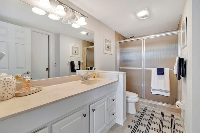 bathroom featuring walk in shower, tile patterned flooring, vanity, and toilet