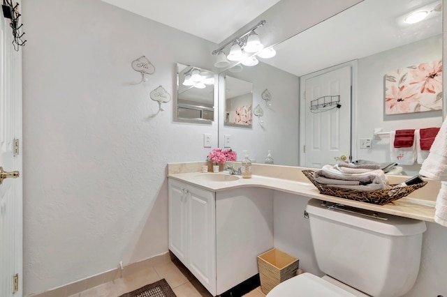 bathroom featuring vanity, toilet, and tile patterned floors