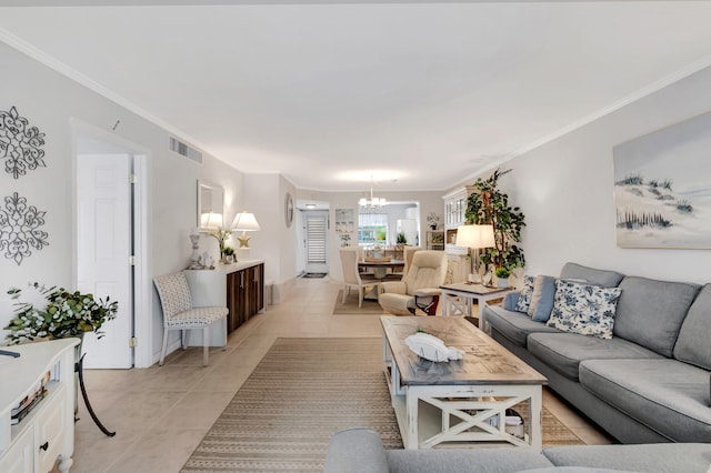 living room with a notable chandelier, light tile patterned floors, and crown molding