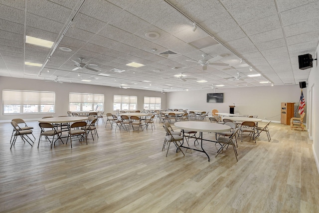 dining space with light wood-type flooring and ceiling fan