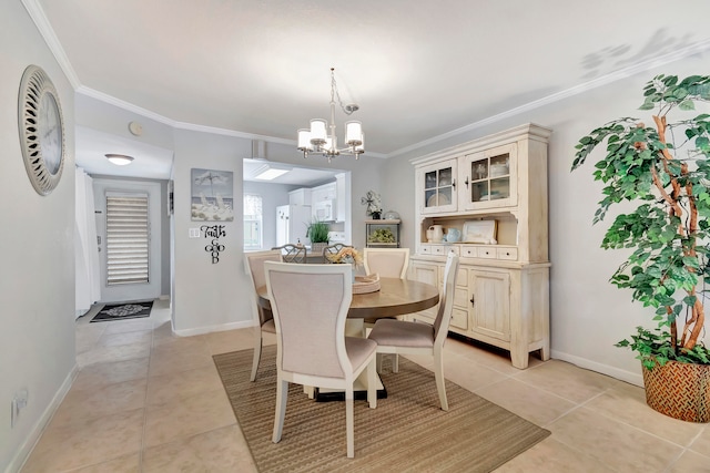 tiled dining area with ornamental molding and an inviting chandelier