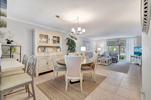 dining room with crown molding, an inviting chandelier, and light tile patterned floors