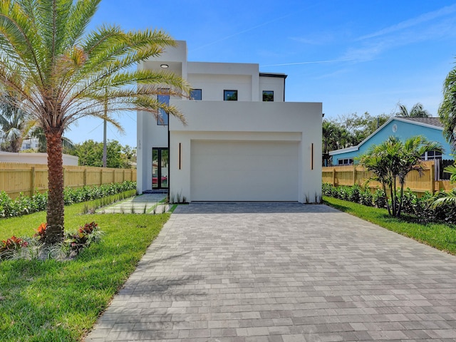 contemporary house with a front yard and a garage