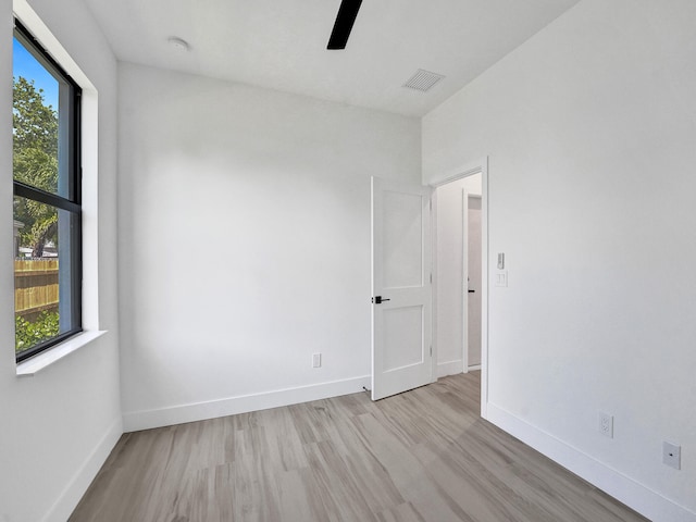 empty room with ceiling fan and light wood-type flooring