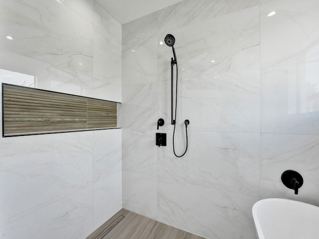 bathroom with a tile shower