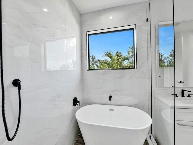 bathroom featuring independent shower and bath and tile walls