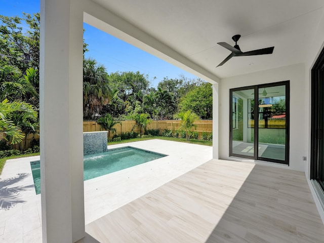 view of pool with a patio and ceiling fan