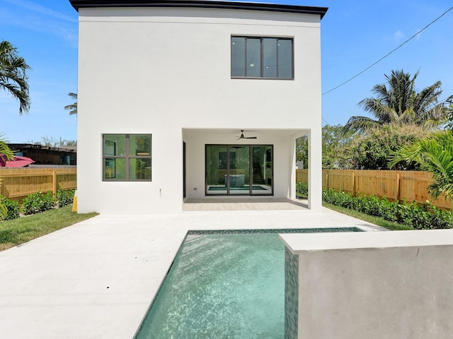 rear view of house featuring ceiling fan and a patio