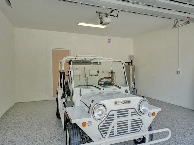 garage featuring water heater and a garage door opener