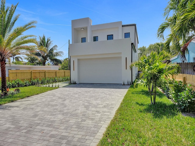 view of front of house with a front lawn and a garage