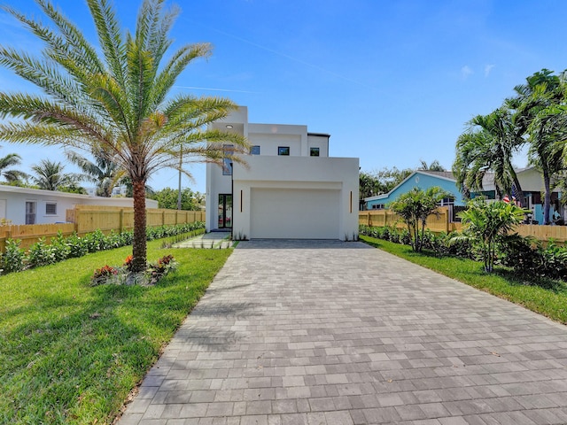 contemporary home with a front lawn and a garage