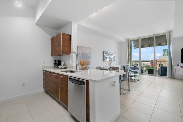 kitchen with dishwasher, sink, expansive windows, light tile patterned floors, and kitchen peninsula