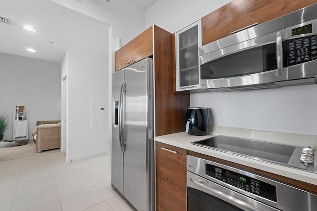 kitchen with light tile patterned floors and appliances with stainless steel finishes