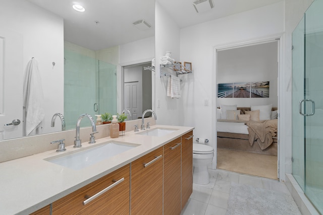 bathroom featuring tile patterned flooring, vanity, toilet, and an enclosed shower