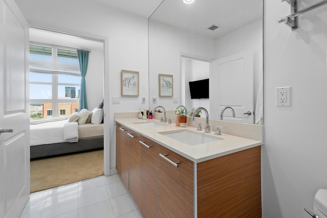 bathroom with tile patterned flooring and vanity