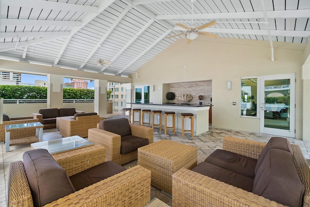 sunroom featuring vaulted ceiling with beams, wood ceiling, and ceiling fan