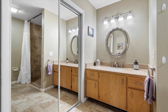 bathroom with vanity, a textured ceiling, and tile floors