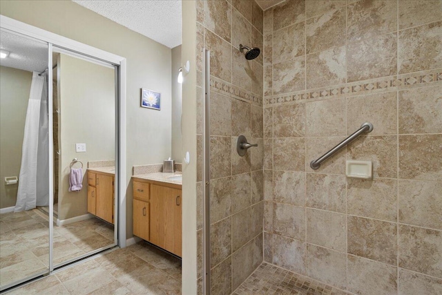 bathroom with tile flooring, a shower with shower curtain, a textured ceiling, and vanity