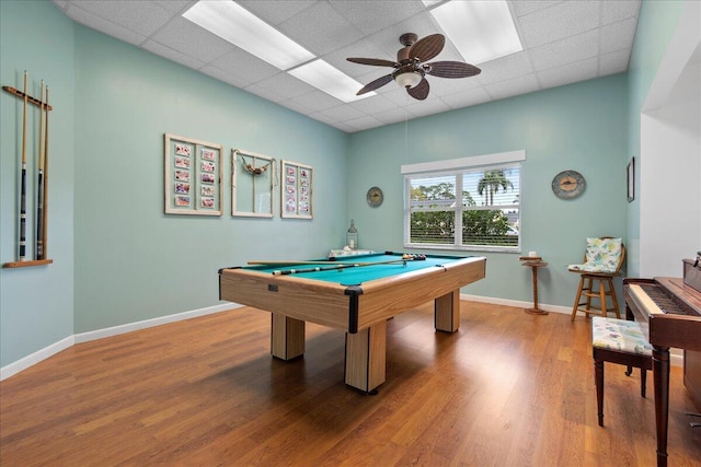 playroom with ceiling fan, hardwood / wood-style flooring, pool table, and a drop ceiling