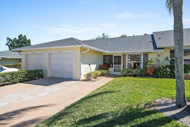 ranch-style house featuring a garage and a front yard