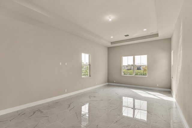 empty room with a raised ceiling