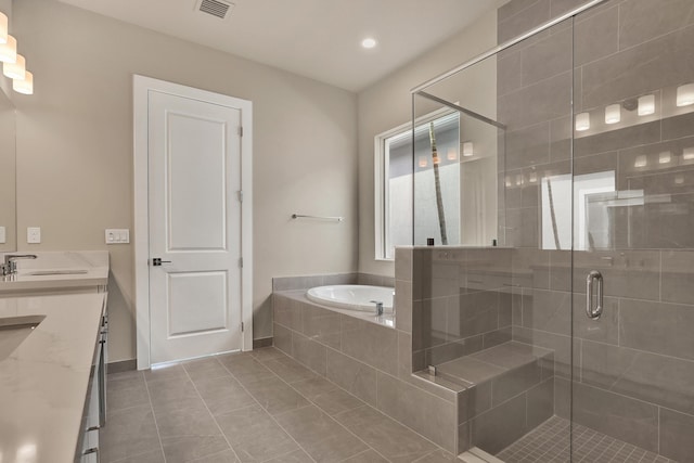 bathroom with tile patterned floors, vanity, and independent shower and bath