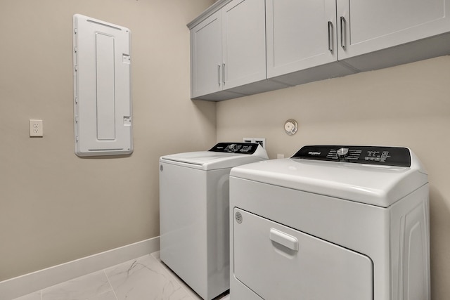 washroom featuring electric panel, cabinets, and independent washer and dryer