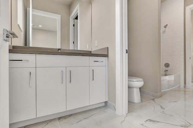 full bathroom with vanity, toilet, and tiled shower / bath