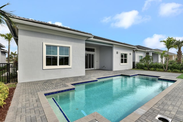 back of house featuring a fenced in pool and a patio area