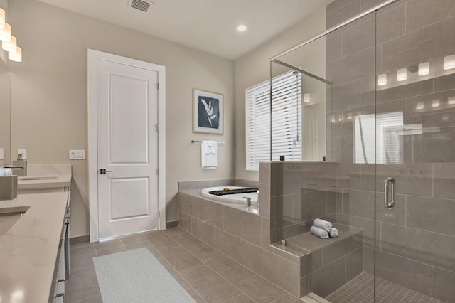 bathroom with shower with separate bathtub, vanity, tile patterned floors, and plenty of natural light