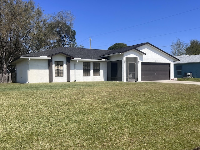 ranch-style house featuring central AC unit, a front yard, and a garage