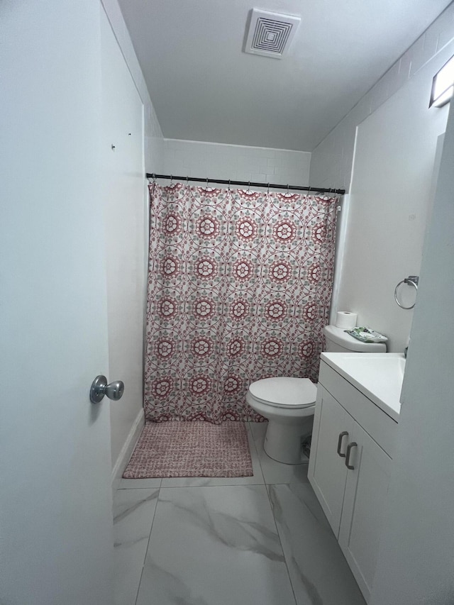 bathroom featuring toilet, tile flooring, and vanity