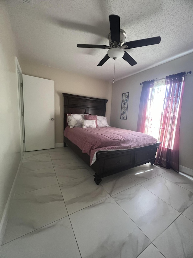 tiled bedroom featuring a textured ceiling and ceiling fan