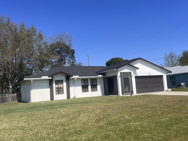 ranch-style house featuring a front yard, central AC, and a garage