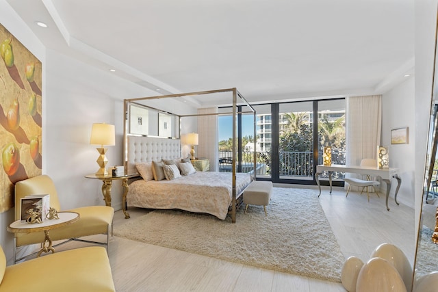 bedroom with floor to ceiling windows and access to outside