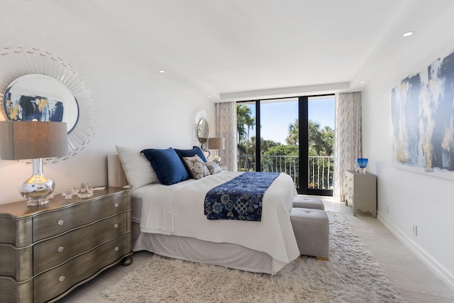 bedroom featuring light hardwood / wood-style floors and access to outside