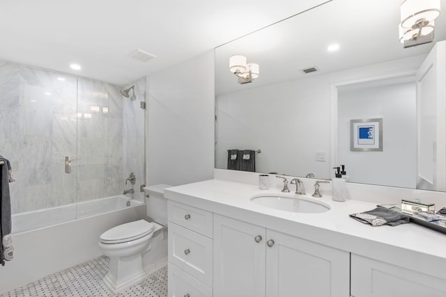 full bathroom with toilet, tile floors, tiled shower / bath combo, and vanity