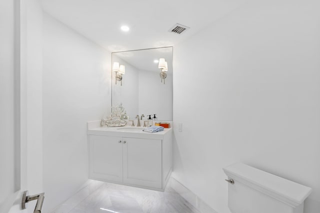 bathroom with toilet and vanity