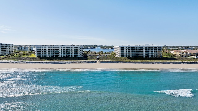 view of swimming pool featuring a beach view and a water view