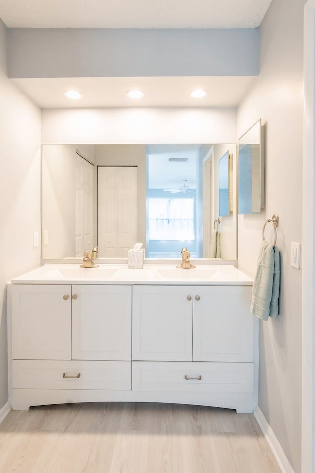 bathroom featuring dual vanity and hardwood / wood-style flooring