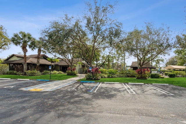 view of parking featuring a lawn