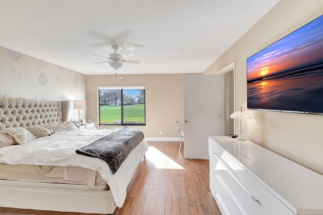 bedroom with ceiling fan and light hardwood / wood-style flooring