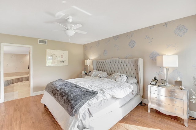 bedroom featuring ceiling fan, connected bathroom, and light hardwood / wood-style floors