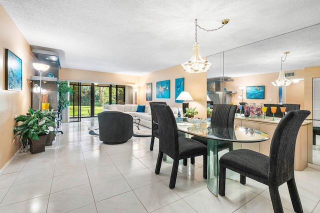 dining area featuring a textured ceiling, an inviting chandelier, and light tile patterned flooring