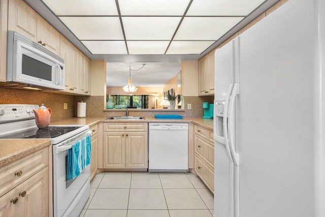 kitchen with decorative backsplash, light brown cabinetry, white appliances, and sink