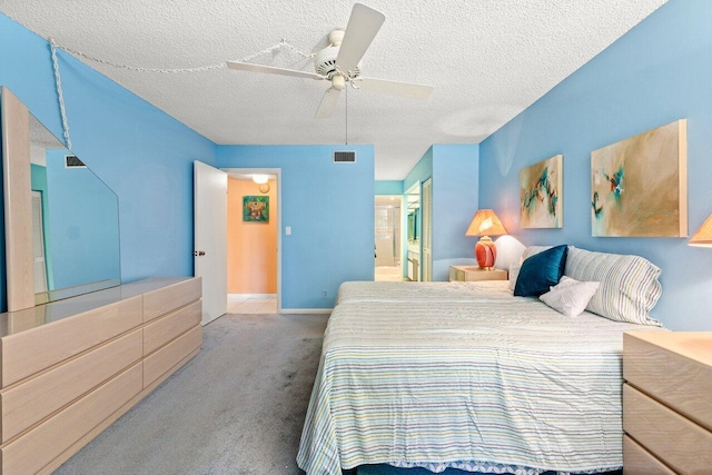 5087 Oak Hill Ln Unit 315, Delray Beach, FL 33484 - carpeted bedroom with ensuite bathroom, a textured ceiling, visible vents, a ceiling fan, and baseboards