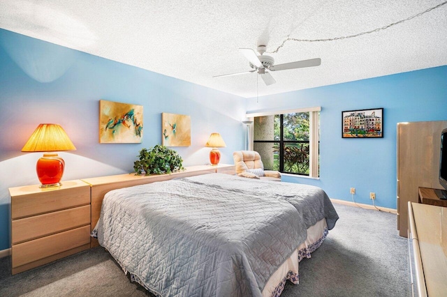 carpeted bedroom with ceiling fan and a textured ceiling