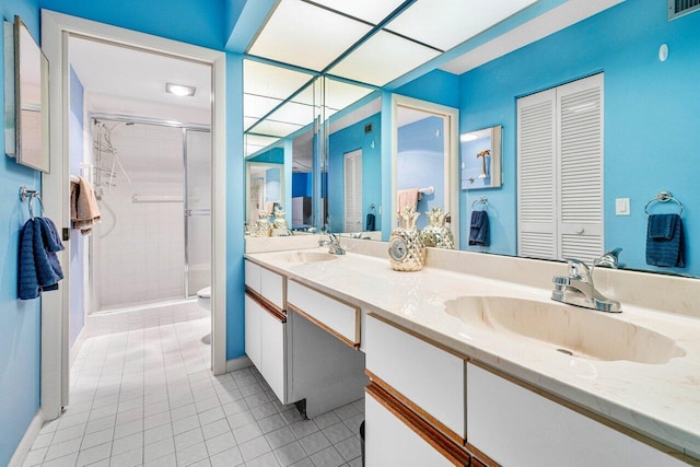 bathroom with vanity, tile patterned floors, and walk in shower