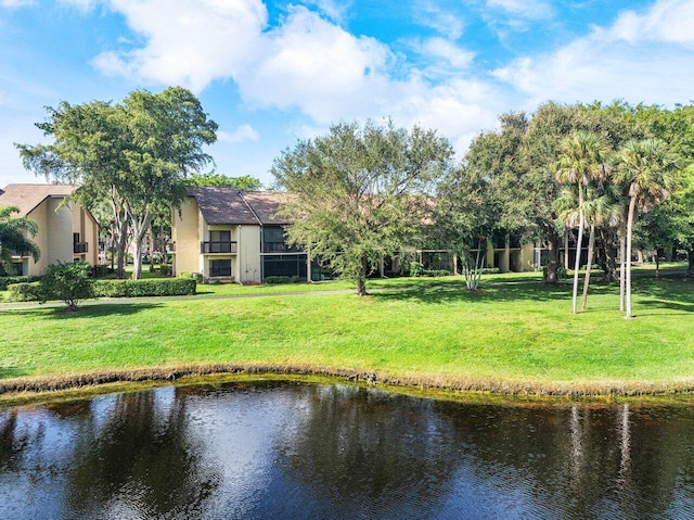 5087 Oak Hill Ln Unit 315, Delray Beach, FL 33484 - back of house with stucco siding, a water view, and a lawn