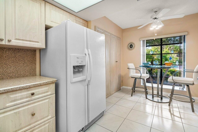 5087 Oak Hill Ln Unit 315, Delray Beach, FL 33484 - kitchen featuring light tile patterned floors, white refrigerator with ice dispenser, ceiling fan, light countertops, and decorative backsplash